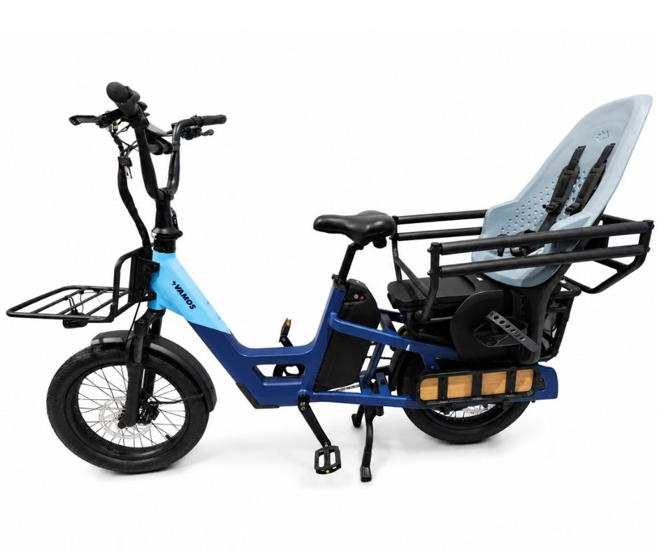 A blue Vamos electric cargo bike equipped with a light blue Thule Yepp 2 Maxi Child Bike Seat on the rear rack.