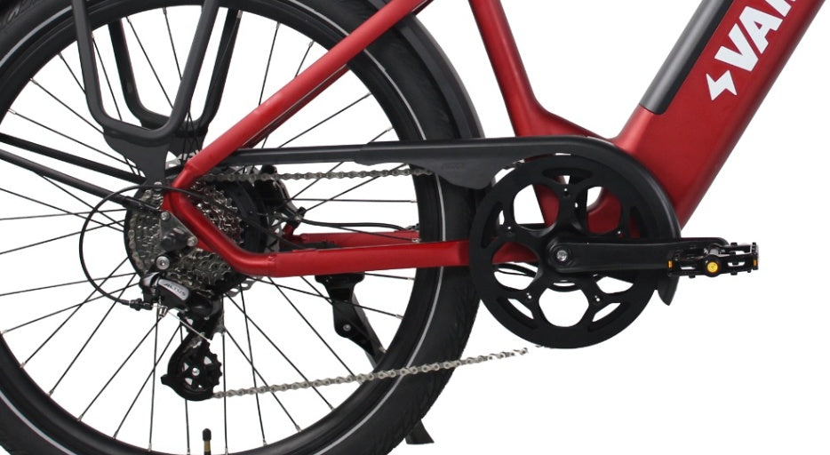 Red step-through frame, rear rack, and drivetrain of a Vamos El Rapido electric commuter bicycle.