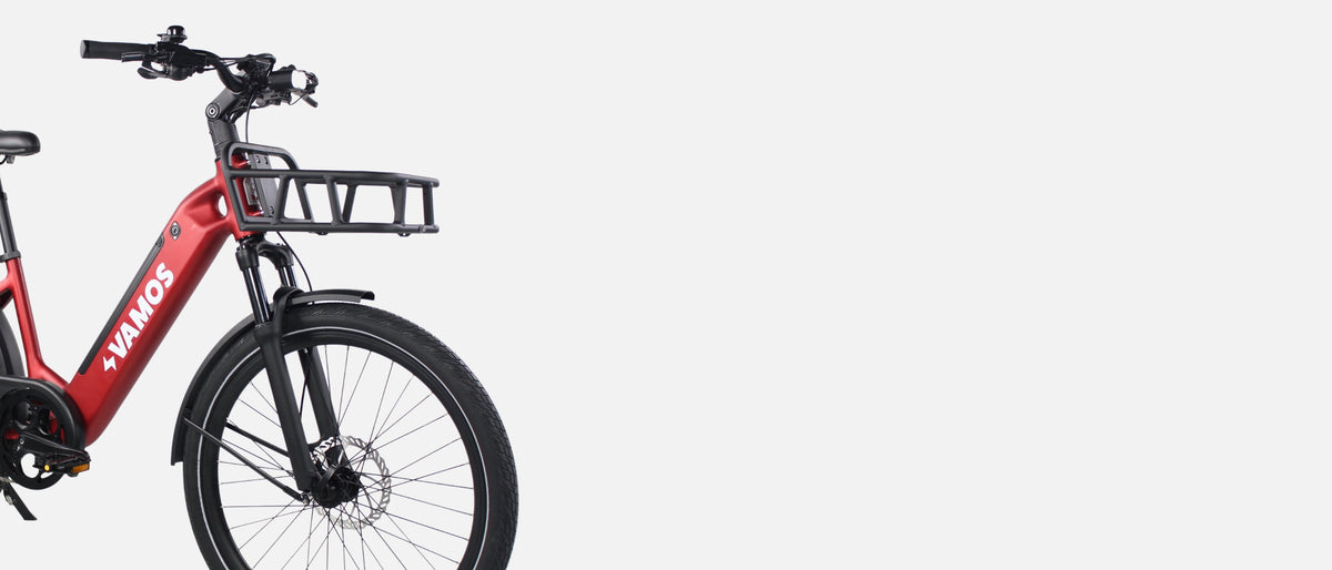 Large promotional banner showing a rider using the Vamos Rapido electric bike for urban commuting.