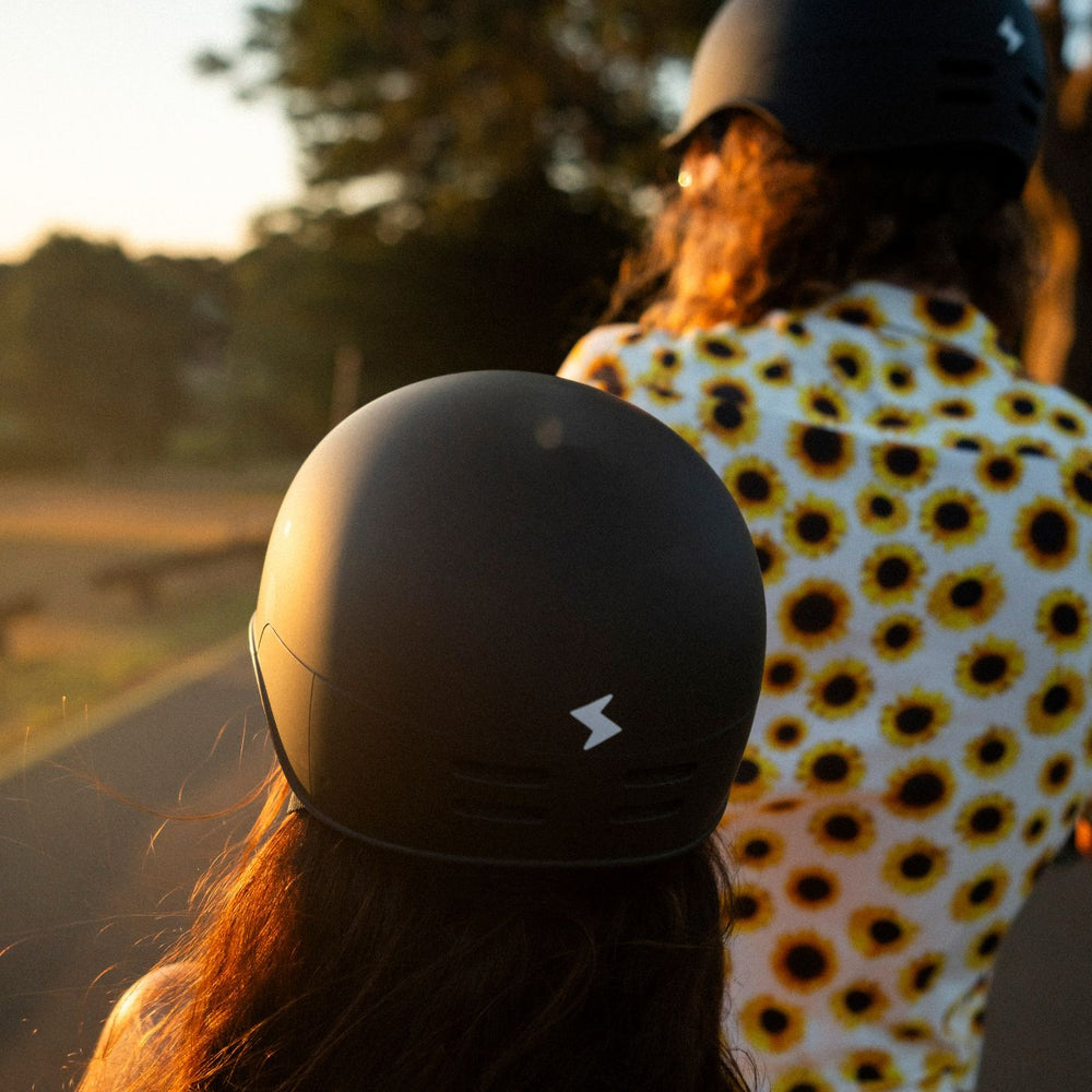 Matte black Vamos Bike Helmet, which includes a reflective lightning bolt logo on the back.