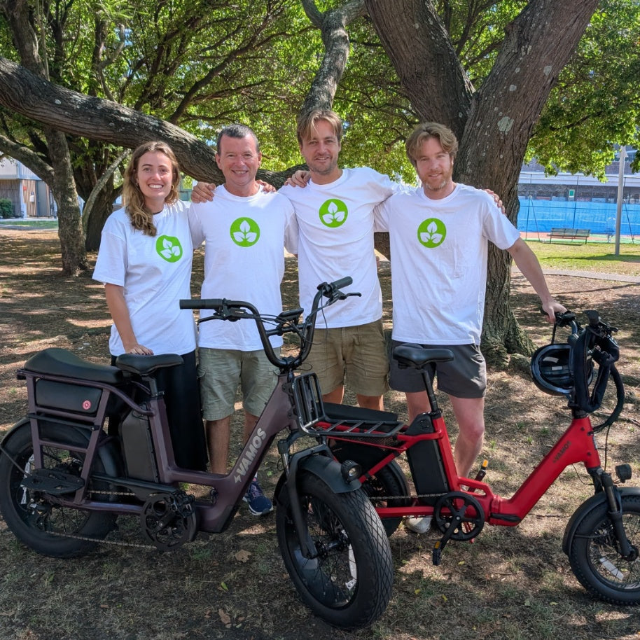 Group photo of four people with Vamos Bikes Amigo compact cargo ebike.