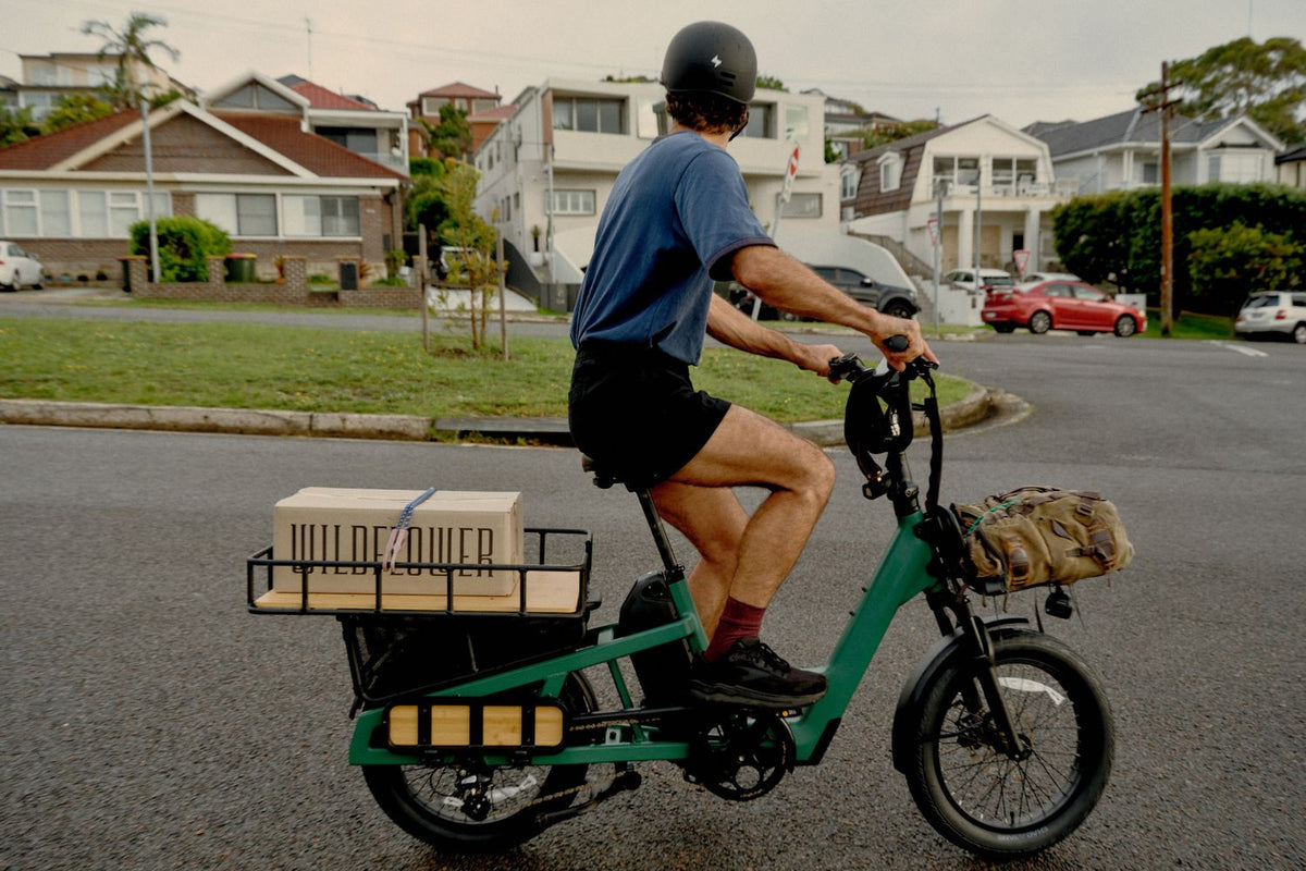Green Vamos Bikes Amigo Plus passenger commuter electric cargo bike in motion