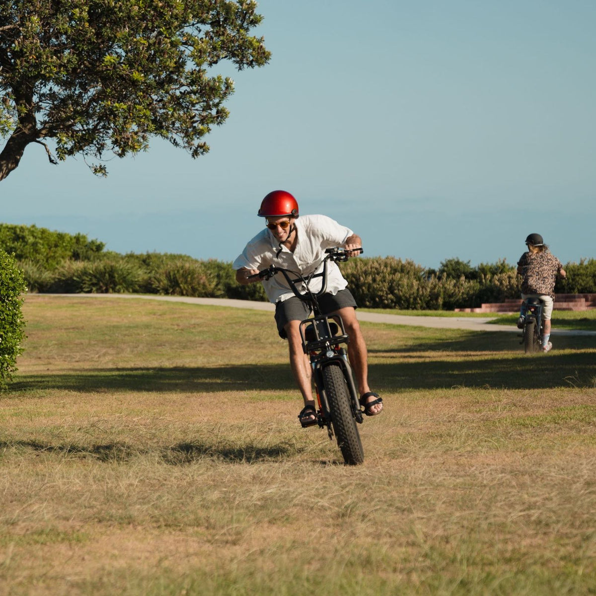Action shot of a Vamos electric bike with wide terrain-gripping tyres being ridden off-road, showcasing the stability and handling of high-torque e-bike motors on uneven surfaces.