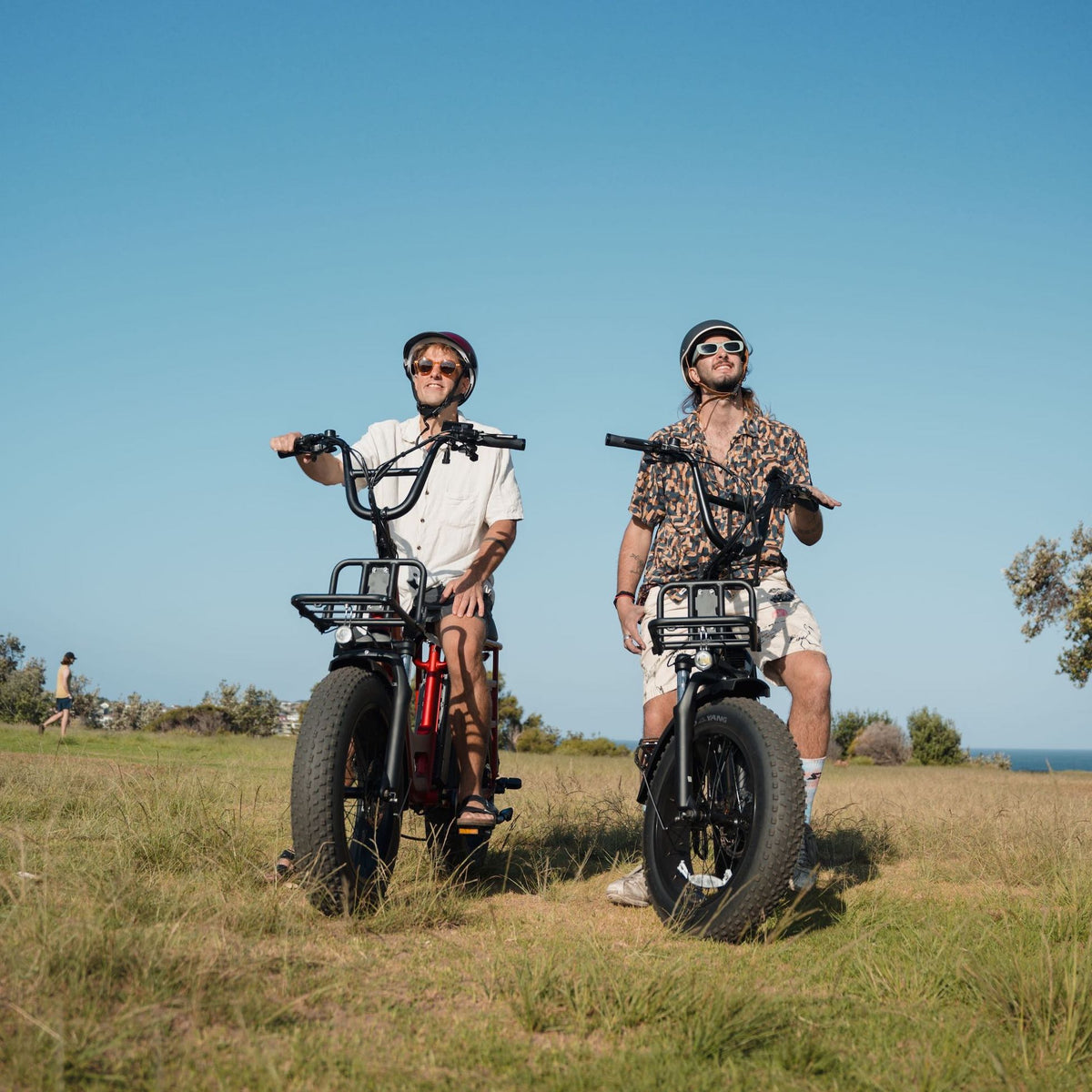Close-up action shot of a two riders using the Vamos Amigo ebike, demonstrating its comfortable upright riding position.