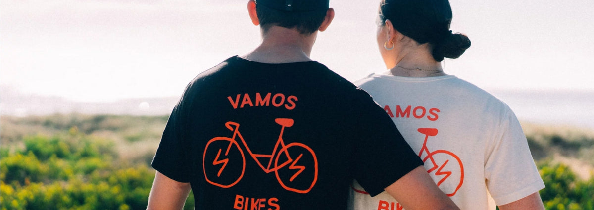 A black graphic t-shirt with an orange bicycle design and the text "VAMOS BIKES" from Vamos Bikes.