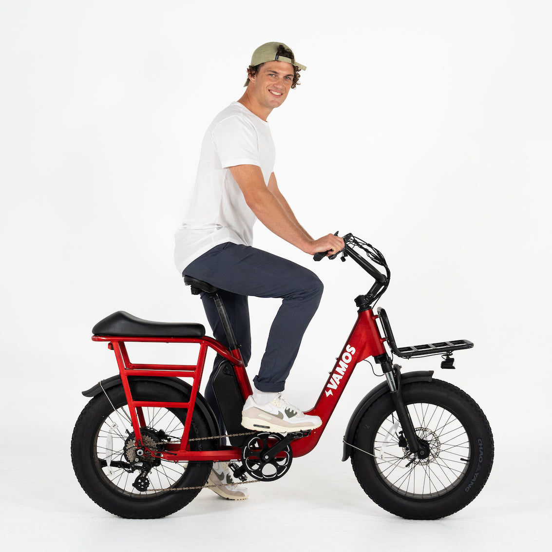 A man in 6”5 / 196cm size riding a Vamos El Amigo 2025 All Purpose Compact Cargo Ebike