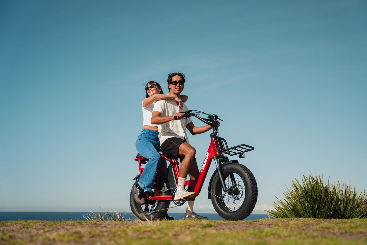 A man riding a Doblez 2026 Foldable EBike and a woman sitting on a rear passenger seat