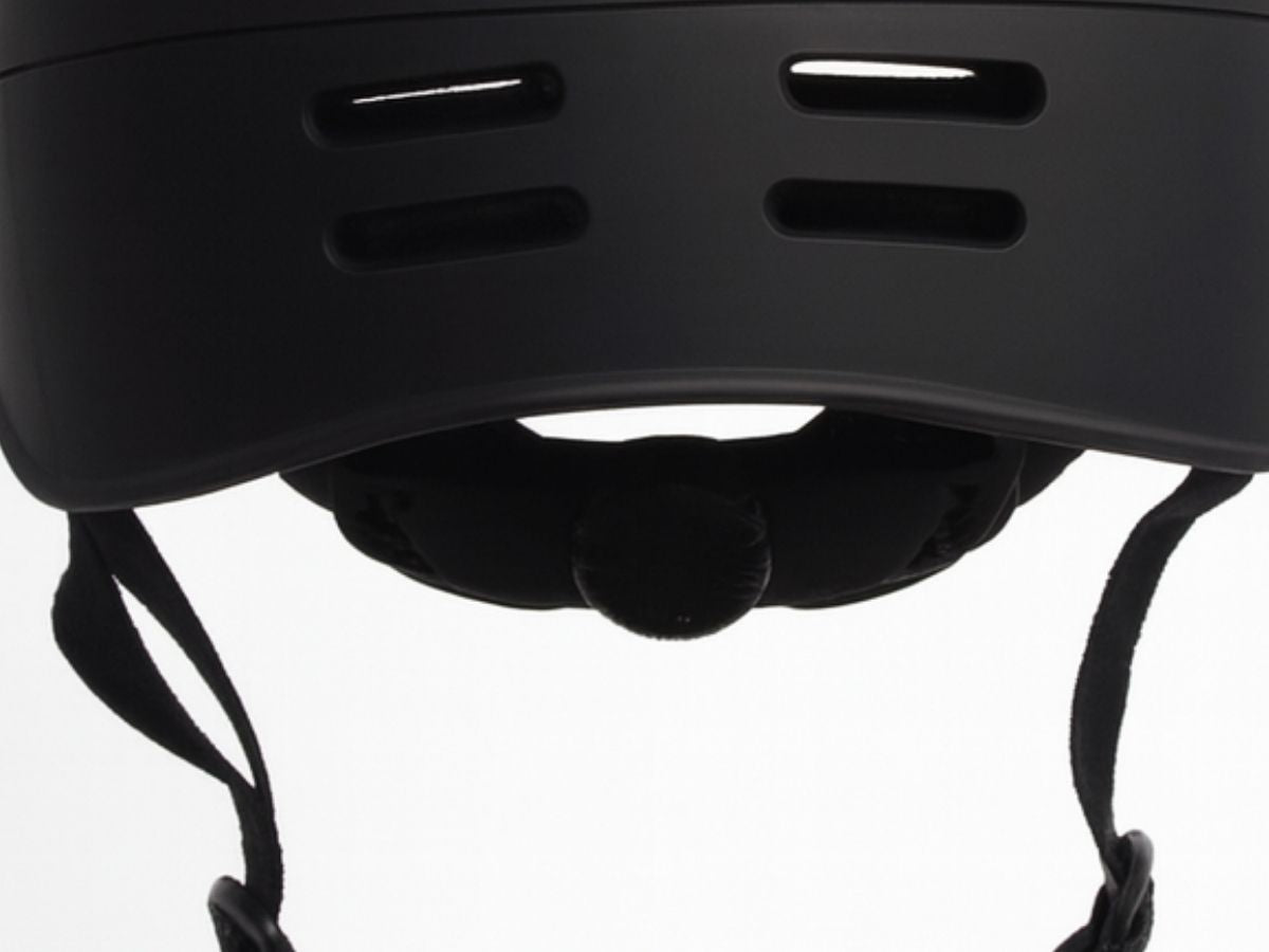 Back view of matte black Vamos bike helmet showing ventilation slots and adjustable fit dial.