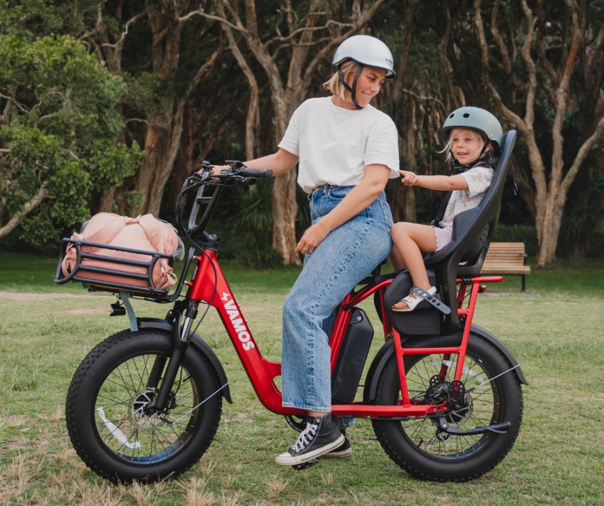 A Red Vamos El Amigo Cargo Electric City Bike equipped with a Thule Yepp 2 Maxi rear child bike seat.
