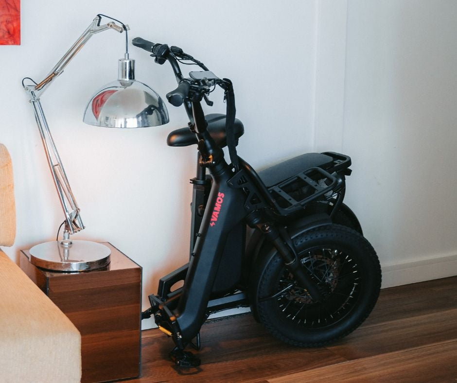 A folded black Vamos Doblez electric bike.