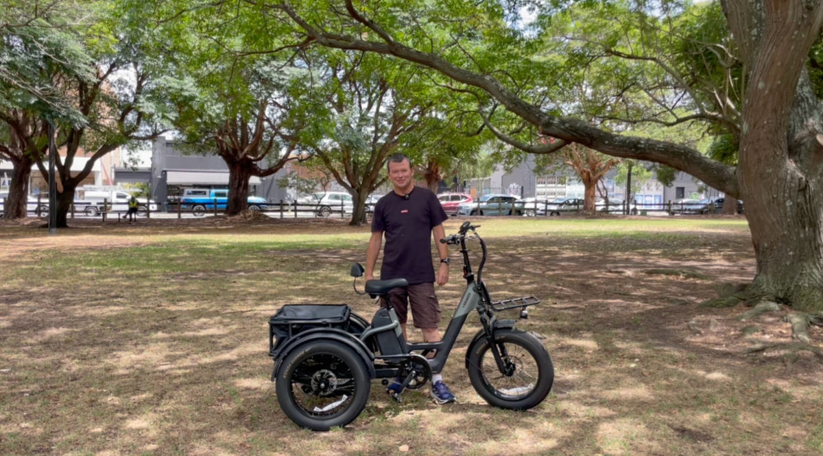 A man under a tree with a balck Papa Grande Pro 2026  3 Wheel Electric Trike
